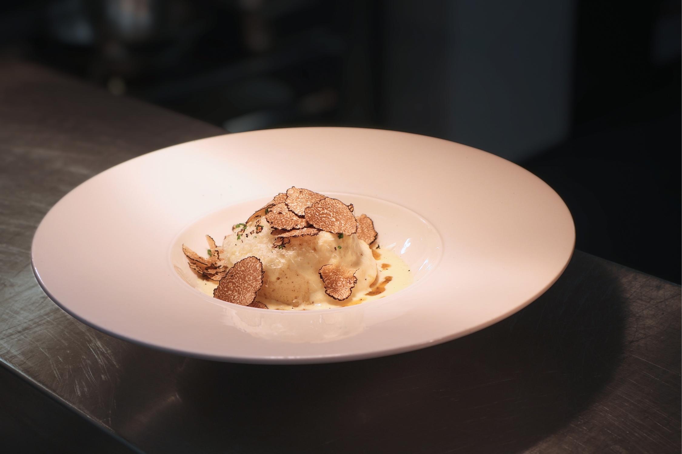 Cheese souffle dish with truffle shavings